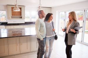 realtor shows house to two interested buyers